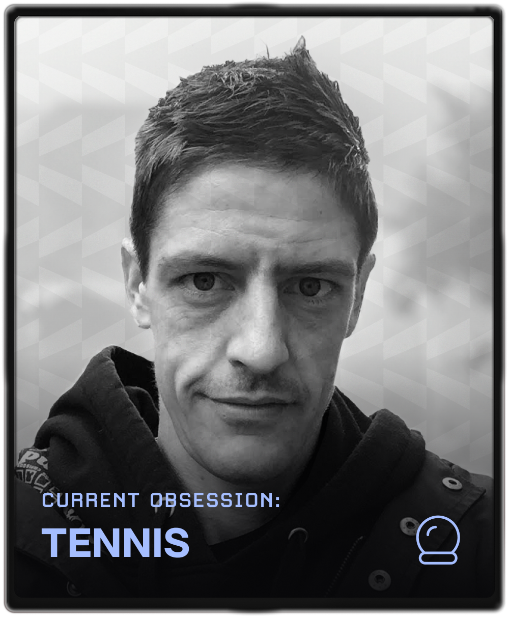 Portrait of a woman with brown hair on a flat gray background.